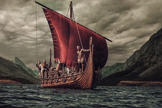 Group of vikings are floating on the sea on Drakkar with mountains on the background